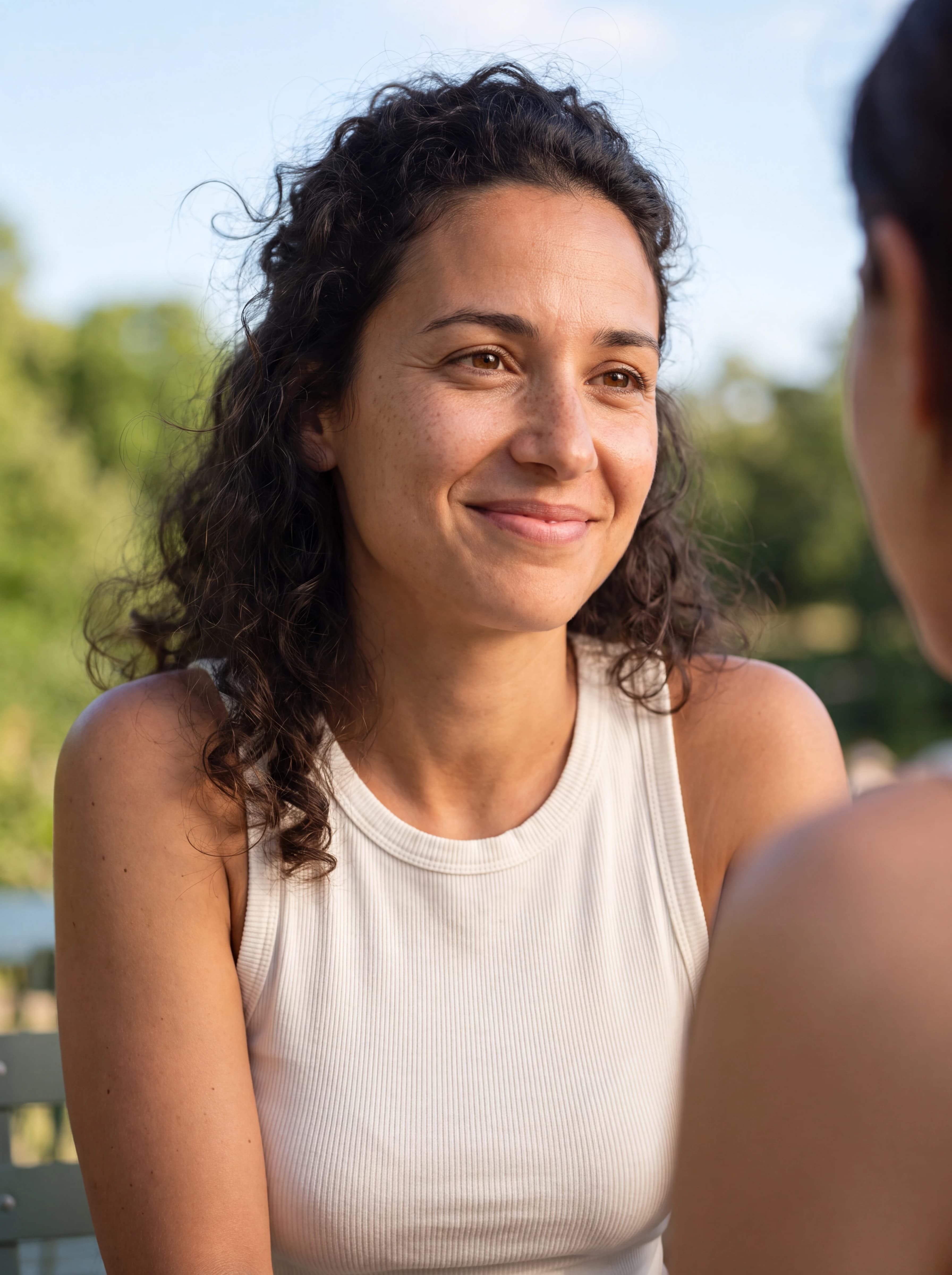 A customer talking with a friend in a park